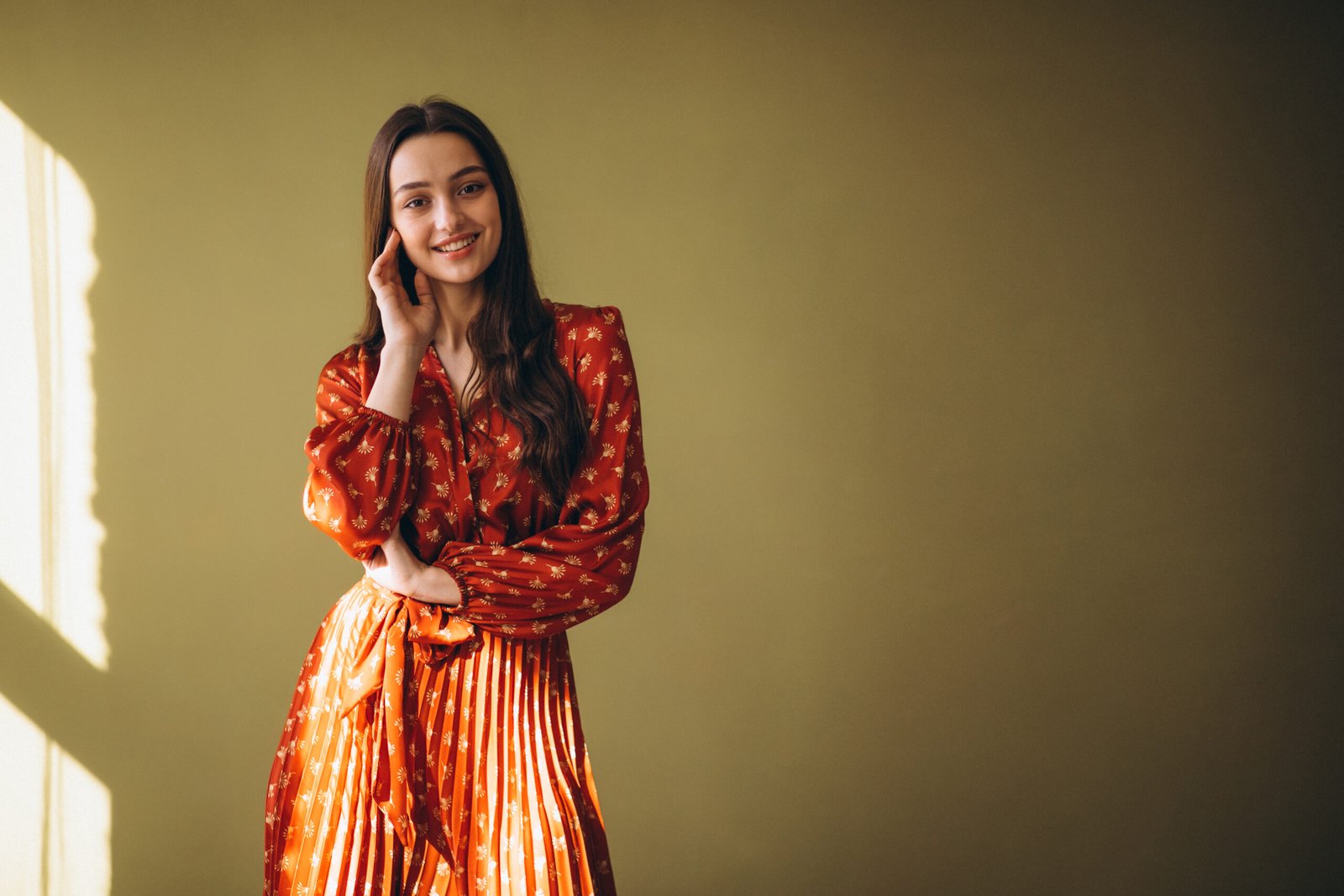 young woman in a beautiful dress in studio